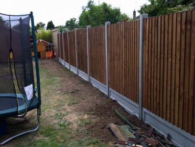 Feathered edge concrete post fence after