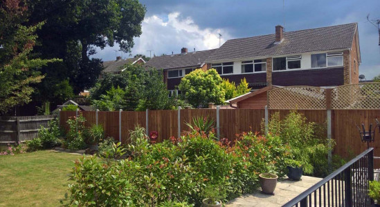 Wooden fence with concrete posts