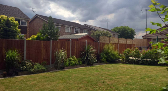 Wooden fence with concrete posts